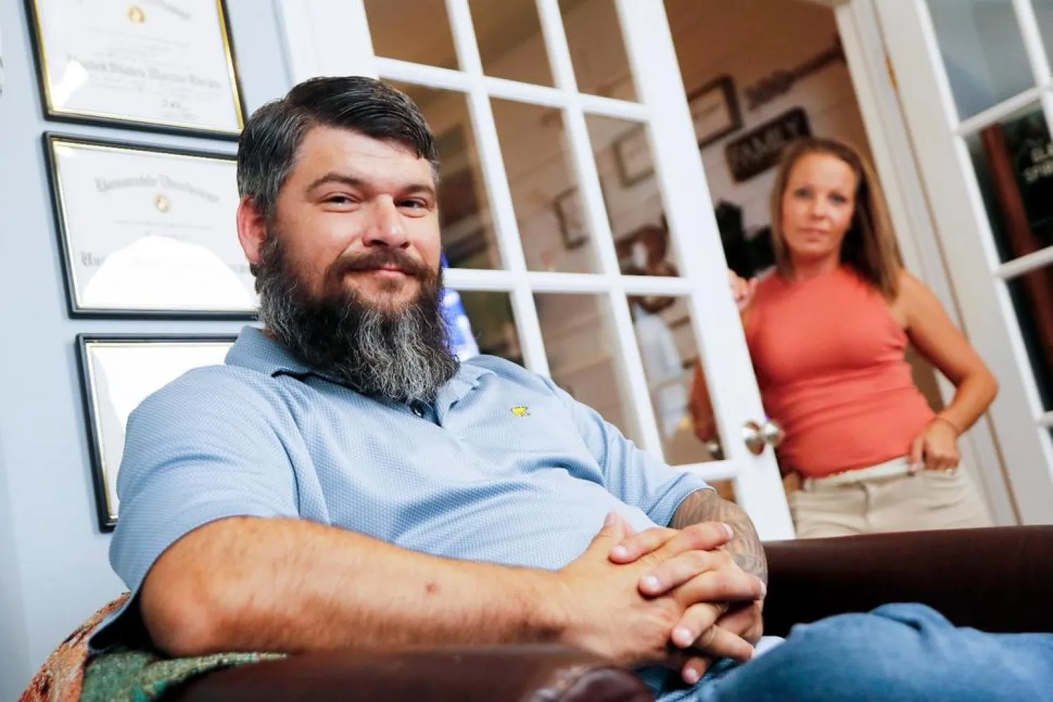 In this Aug. 11, 2021, photo retired Lance Cpl. William Bee poses for a photo with his wife Bobby Jean surrounded by memories of his military service at his home in Jacksonville, NC. (AP)