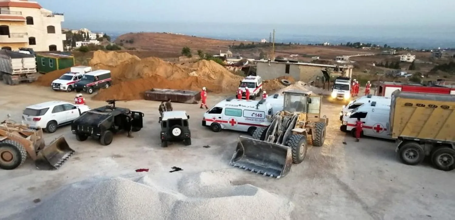 Lebanese army soldiers and Red Cross members are seen near the site of a fuel tanker explosion in Akkar in northern Lebanon, August 15, 2021. (Reuters)