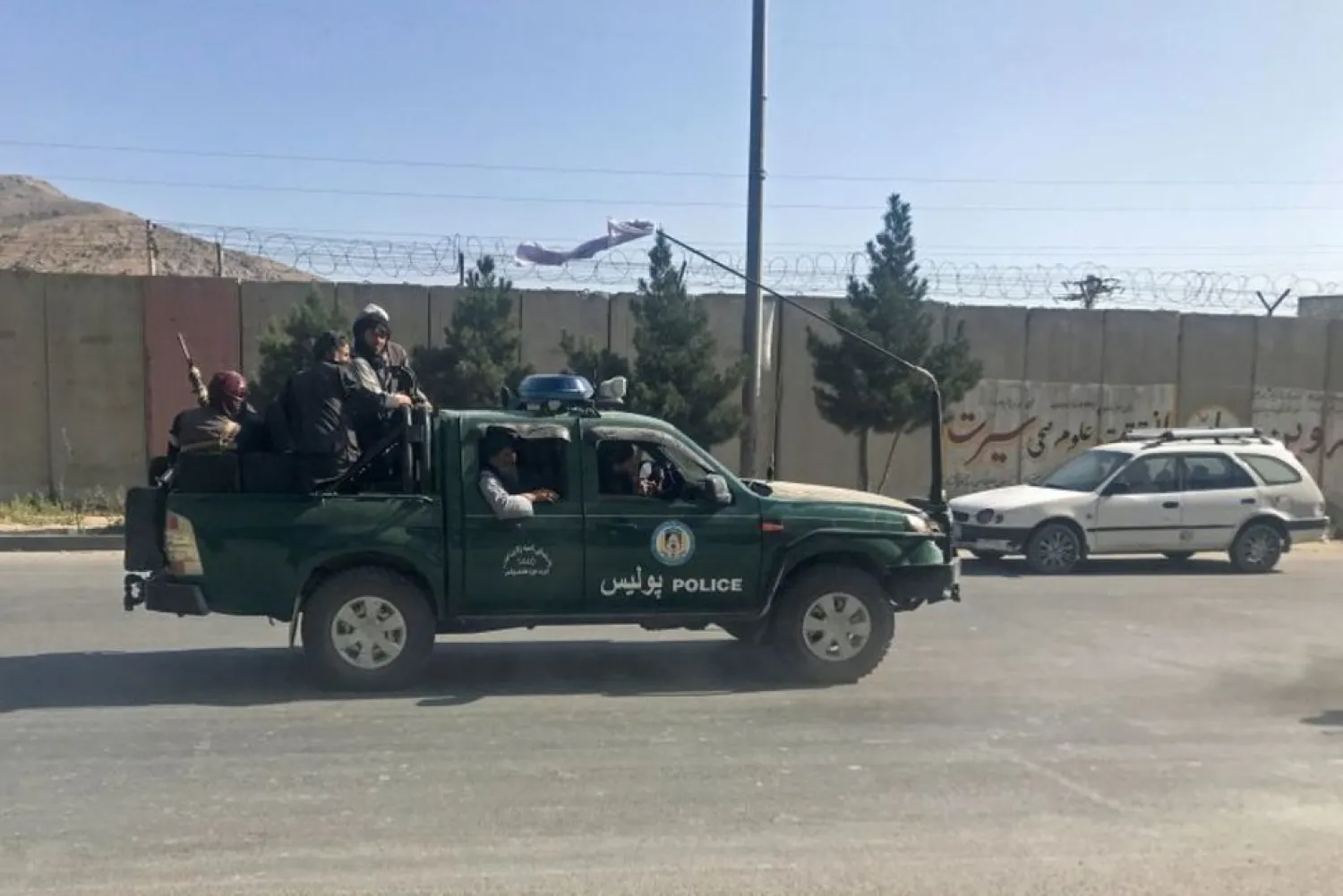 Taliban fighters ride on a police vehicle in Kabul, Afghanistan, August 16, 2021. (Reuters)