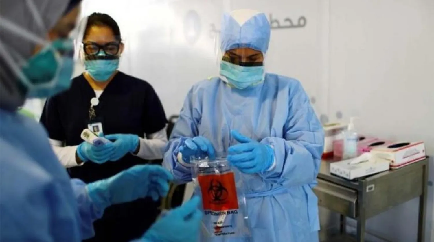 A medical professional carries out a swab test for the COVID-19 virus at a drive-thru testing center in Abu Dhabi, UAE. (File/Reuters)
