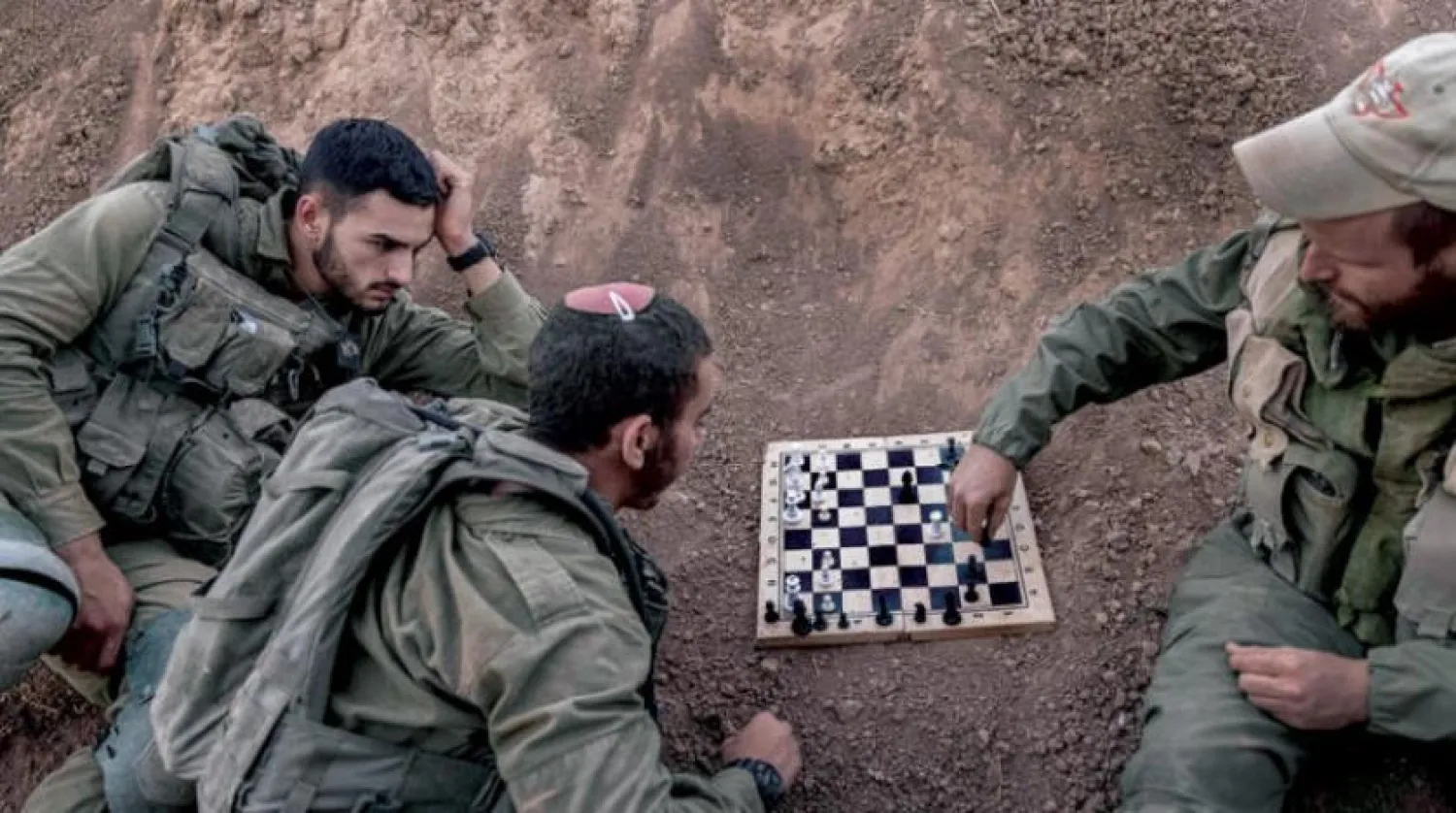 Israeli soldiers playing chess on the border with Gaza (AP)
