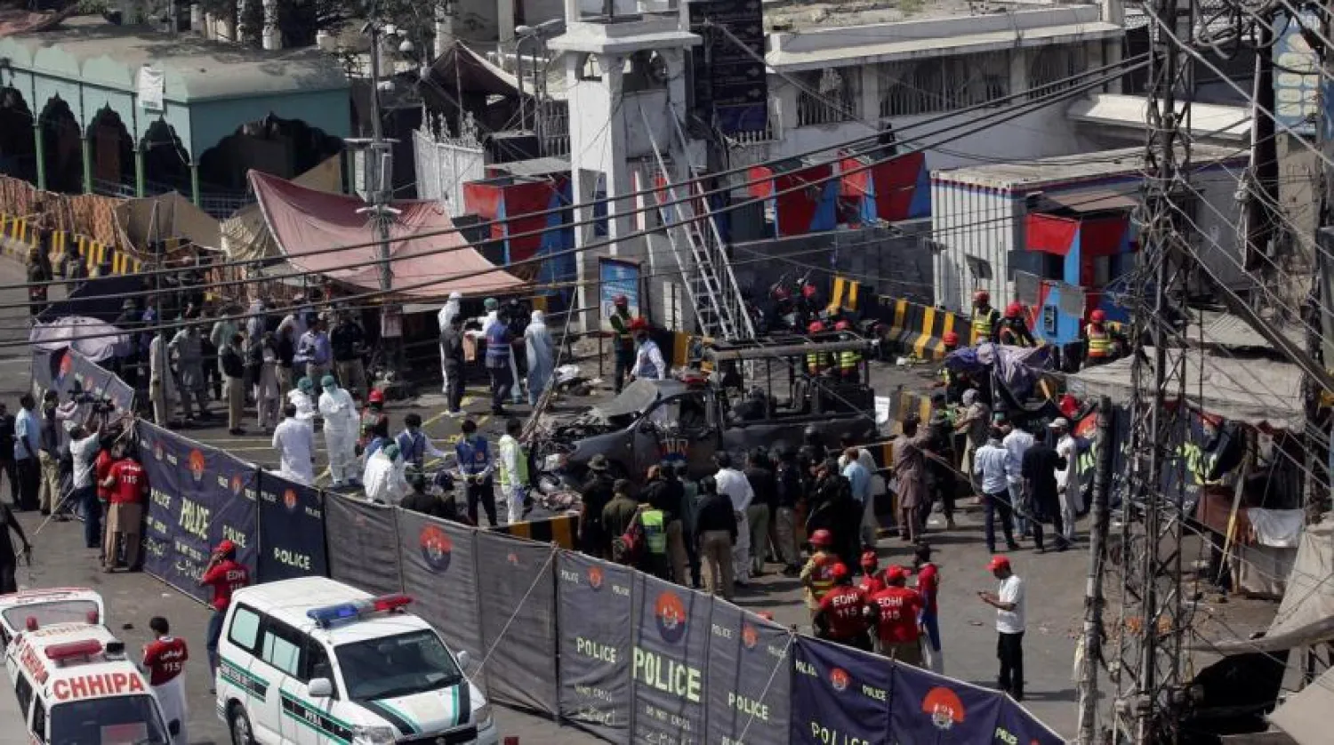 Ambulances are parked outside a cordoned off area as rescue workers and a bomb disposal team survey the site after a blast in Lahore, Pakistan May 8, 2019. (Reuters)
