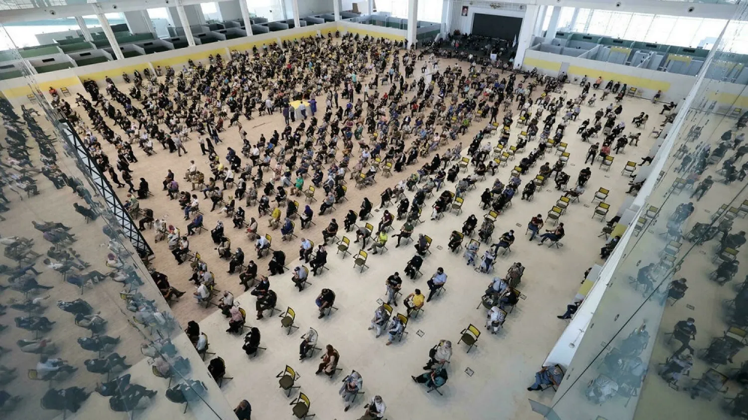 Iranians wait their turn to be inoculated against the coronavirus, at a vaccination centre in Tehran's Iran Mall. (AFP)
