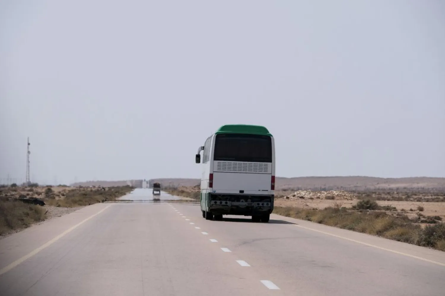 A bus travels towards Tripoli by the newly-reopened coastal road which was cut between the cities of Misrata and Sirte, near Ras Lanuf, Libya August 10, 2021. (Reuters)