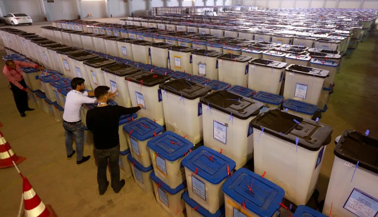 Employees of the Iraqi Independent High Electoral Commission inspect ballot boxes at a warehouse in Najaf, Iraq May 15, 2018. (Reuters)