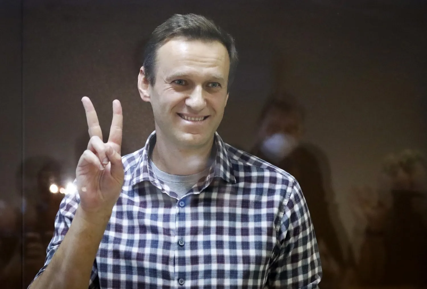 In this Saturday, Feb. 20, 2021 file photo, Russian opposition leader Alexei Navalny gestures as he stands in a cage in the Babuskinsky District Court in Moscow, Russia. (AP)