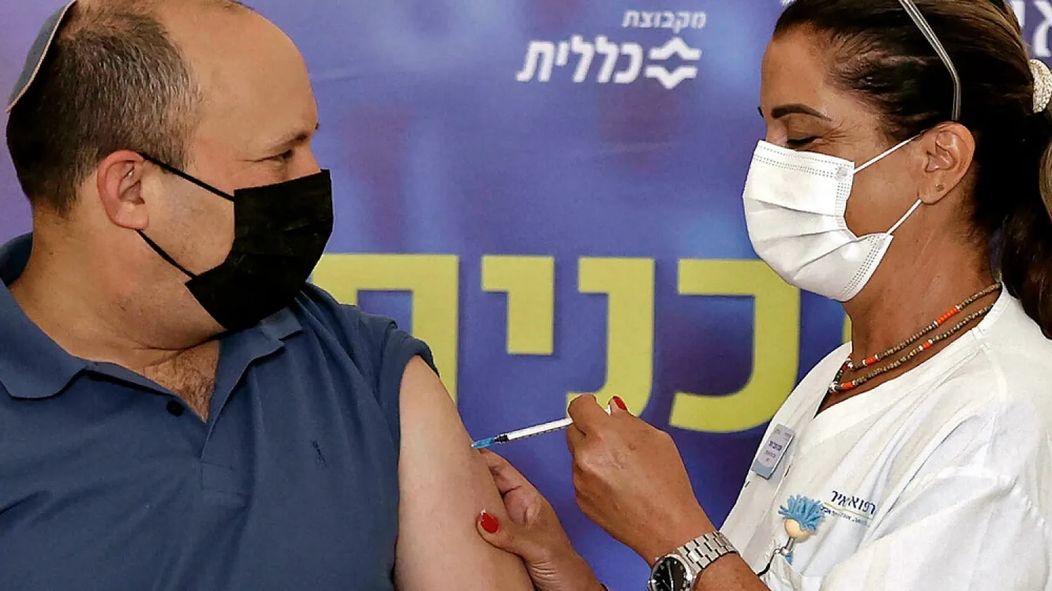 Israeli Prime Minister Naftali Bennett receives a coronavirus booster shot at Meir Medical Center in the central Israeli city of Kfar Saba, on Friday. (AFP)