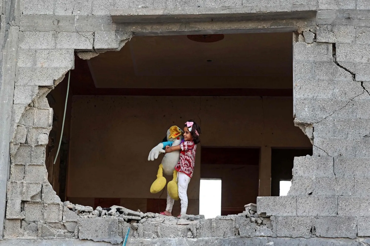 A girl inside her house in Gaza City in August, which was heavily damaged during that latest conflict. (AFP)