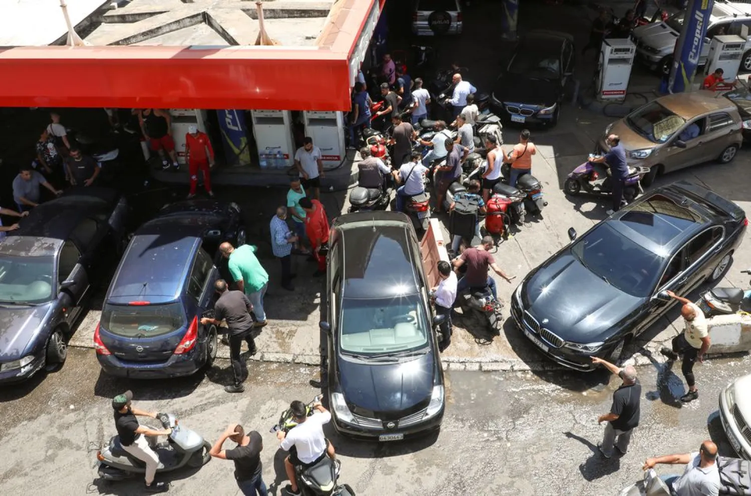 Motorbike and car drivers wait to get fuel at a gas station in Beirut, Lebanon June 29, 2021. (Reuters)