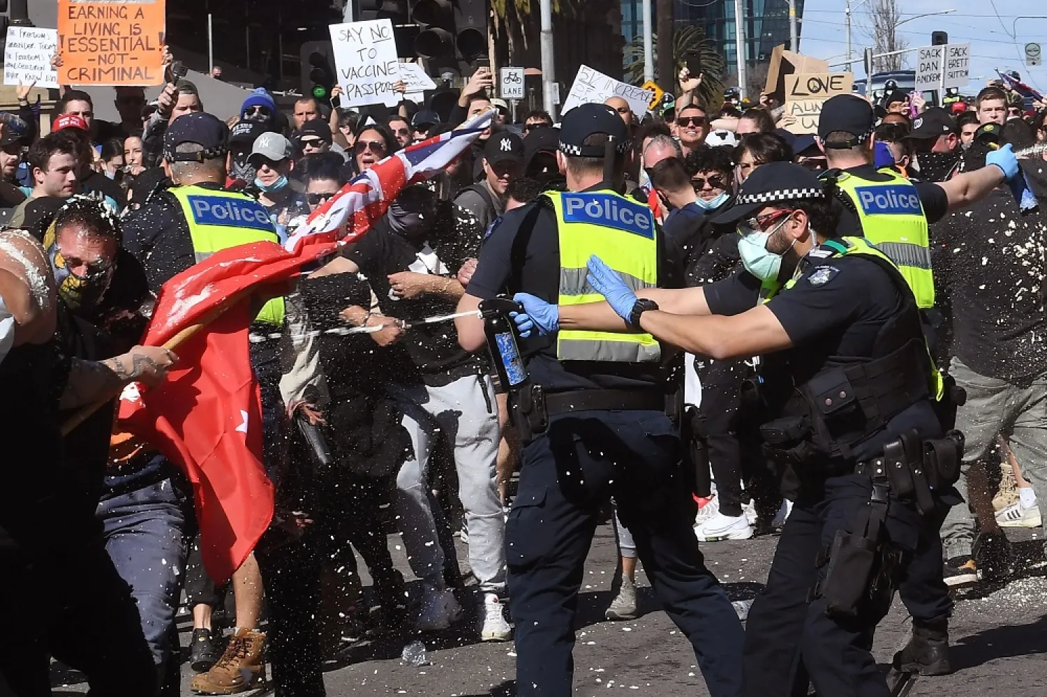 Police pepper spray protesters during an anti-lockdown rally in Melbourne on Saturday. (Getty Images)
