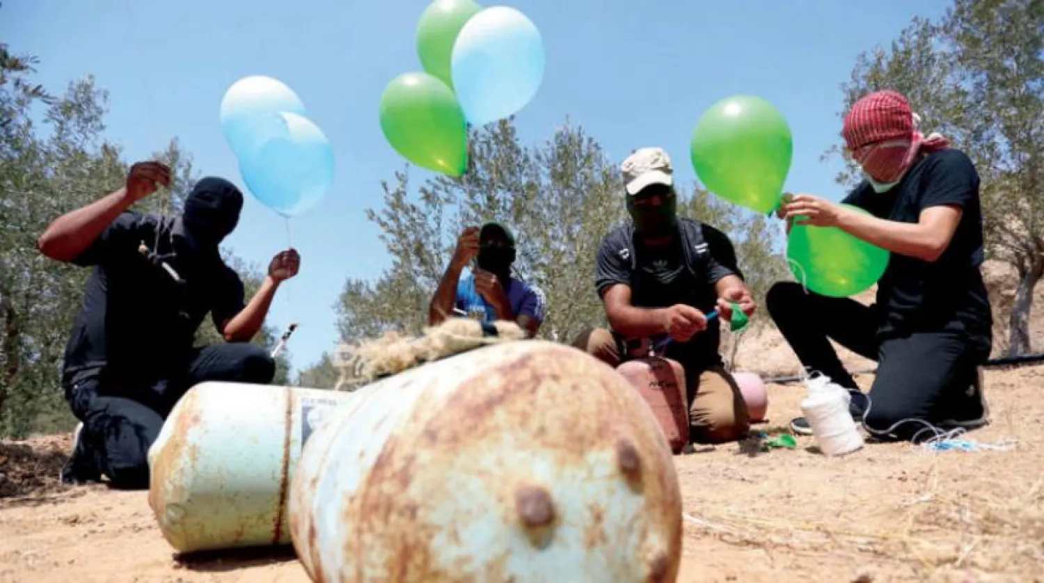 Exploding incendiary balloons are prepared in al-Bureij, Gaza. (dpa)