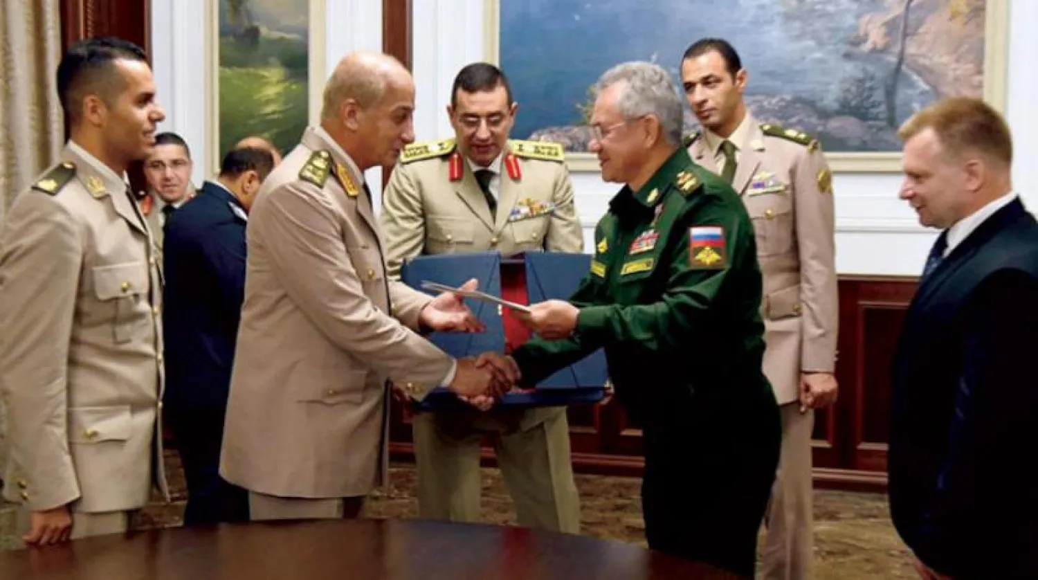 The defense ministers of Egypt and Russia exchange cooperation protocol documents (from the Egyptian military spokesman's Facebook page)
