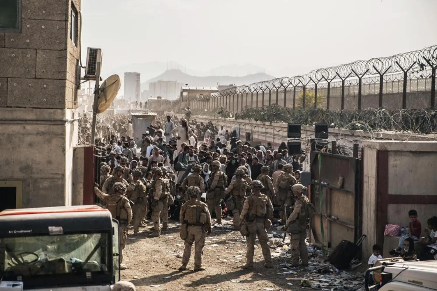 In this Aug. 21, 2021, photo provided by the US Marines, US Marines with Special Purpose Marine Air-Ground Task Force - Crisis Response - Central Command, provide assistance at an evacuation control checkpoint during an evacuation at Hamid Karzai International Airport in Kabul, Afghanistan. (Staff Sgt. Victor Mancilla/US Marine Corps via AP)
