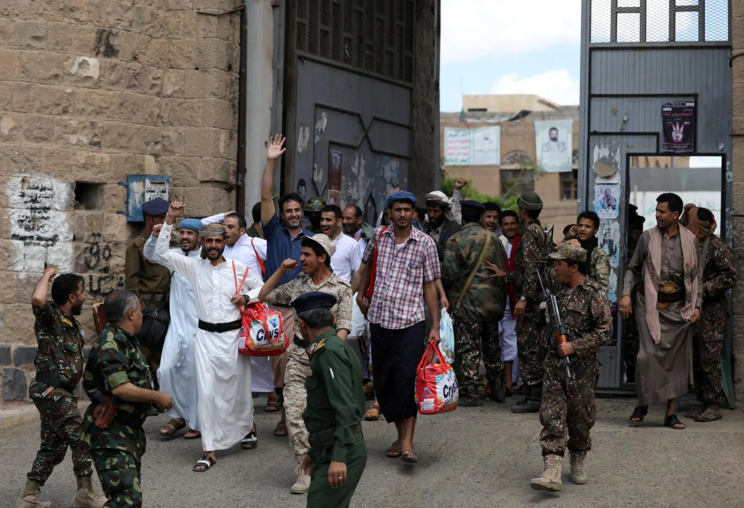 Detainees celebrate as they leave the prison following their release by the Houthis in Sanaa, Yemen (Reuters)
