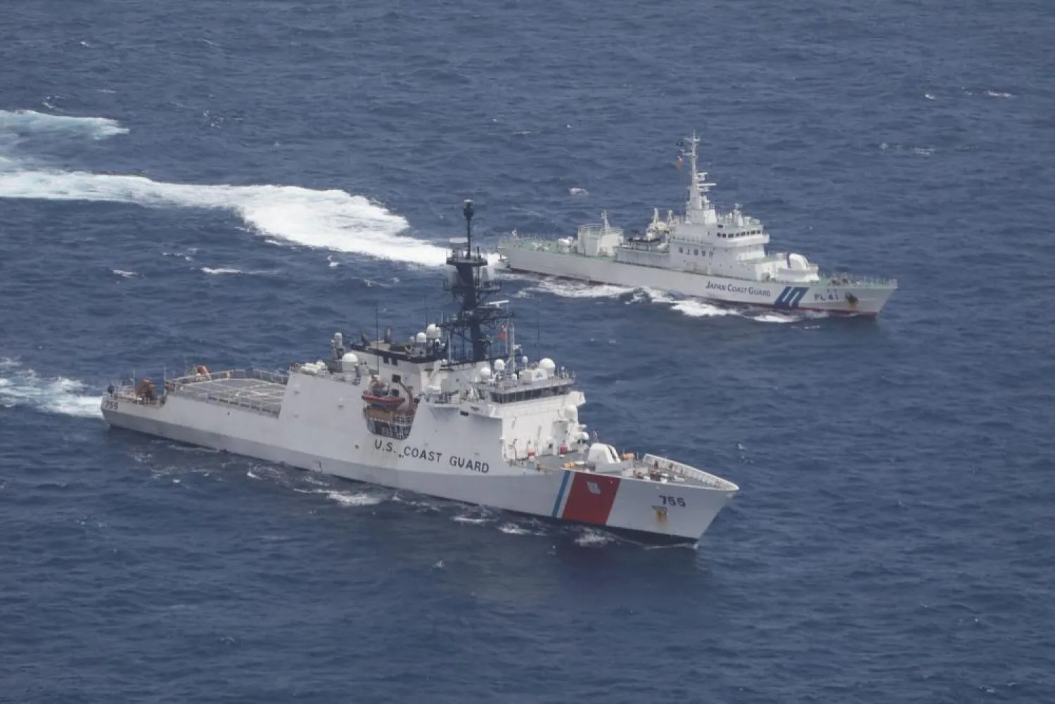In this photo provided by US Coast Guard, Coast Guard cutter Munro, bottom, and Japan Coat Guard patrol vessel Large Aso transit together in formation during a maritime engagement in the East China Sea on Aug. 25, 2021. (U.S. Coast Guard via AP)

