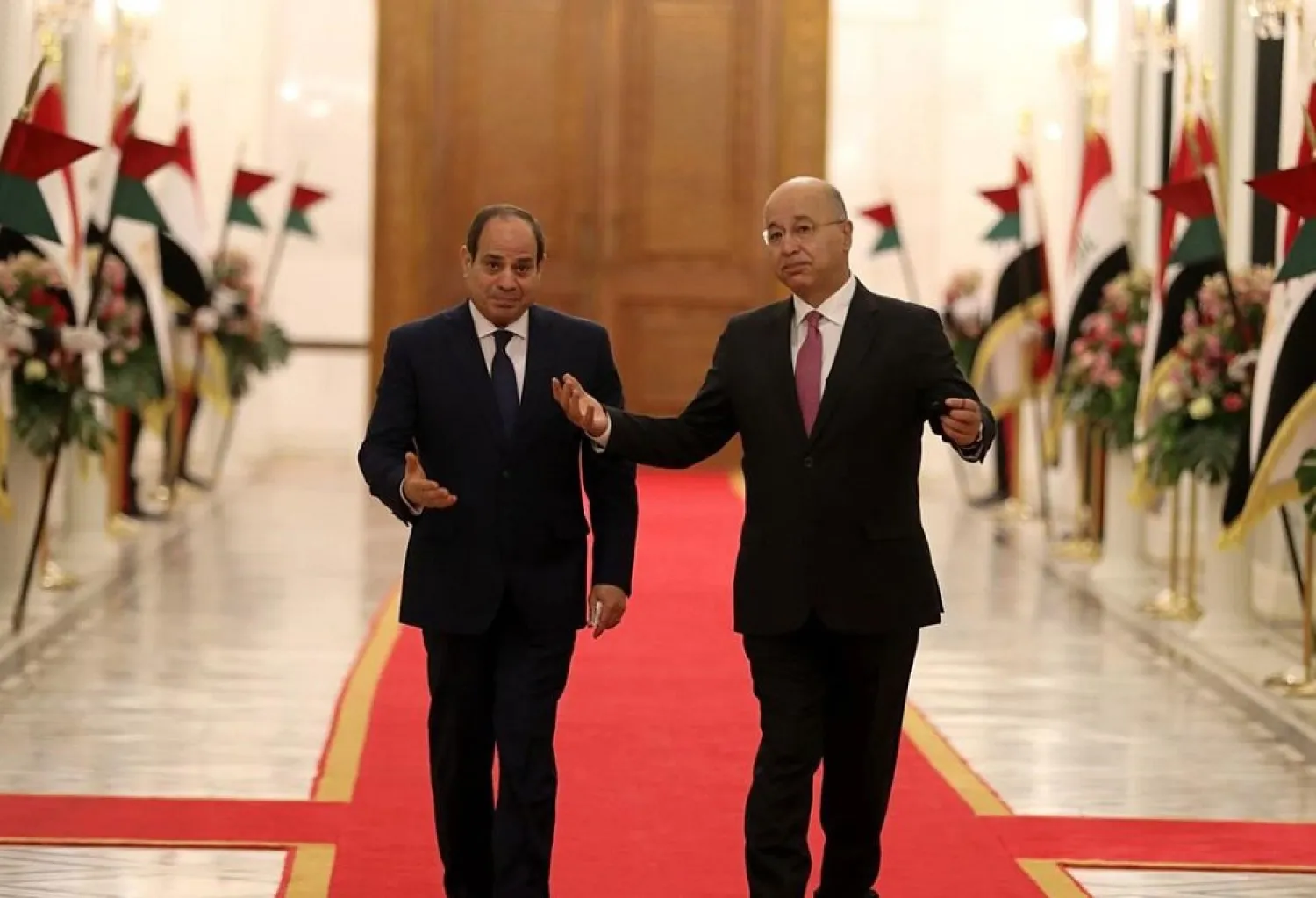 Iraqi President Barham Salih, right, welcomes Egyptian President Abdel Fattah al-Sisi as he arrives at the Baghdad’s Presidential Palace, Saturday, Aug. 28, 2021. (AP)