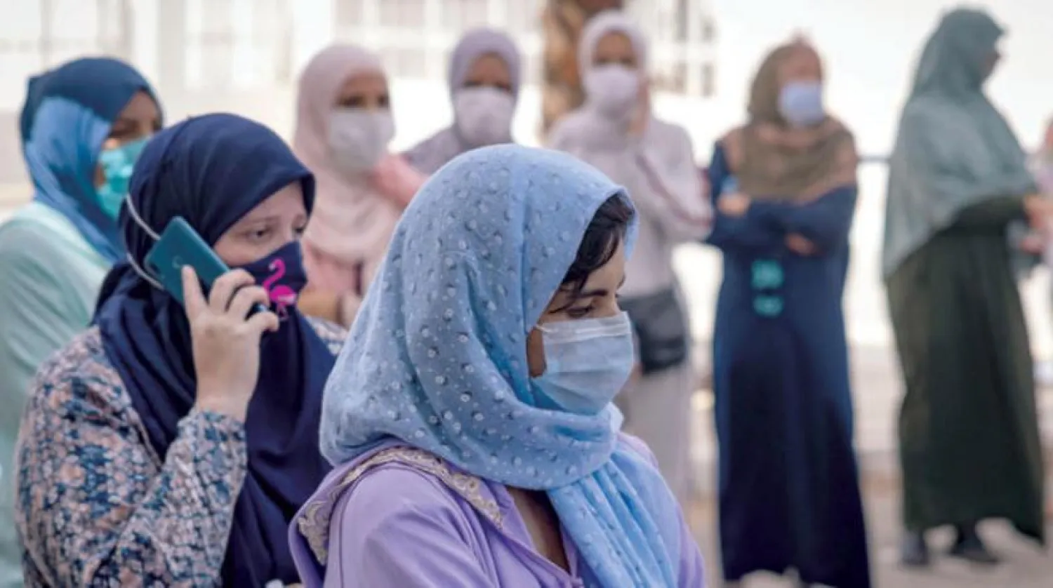 Moroccans wait in line at a vaccination center in Casablanca. (AFP)