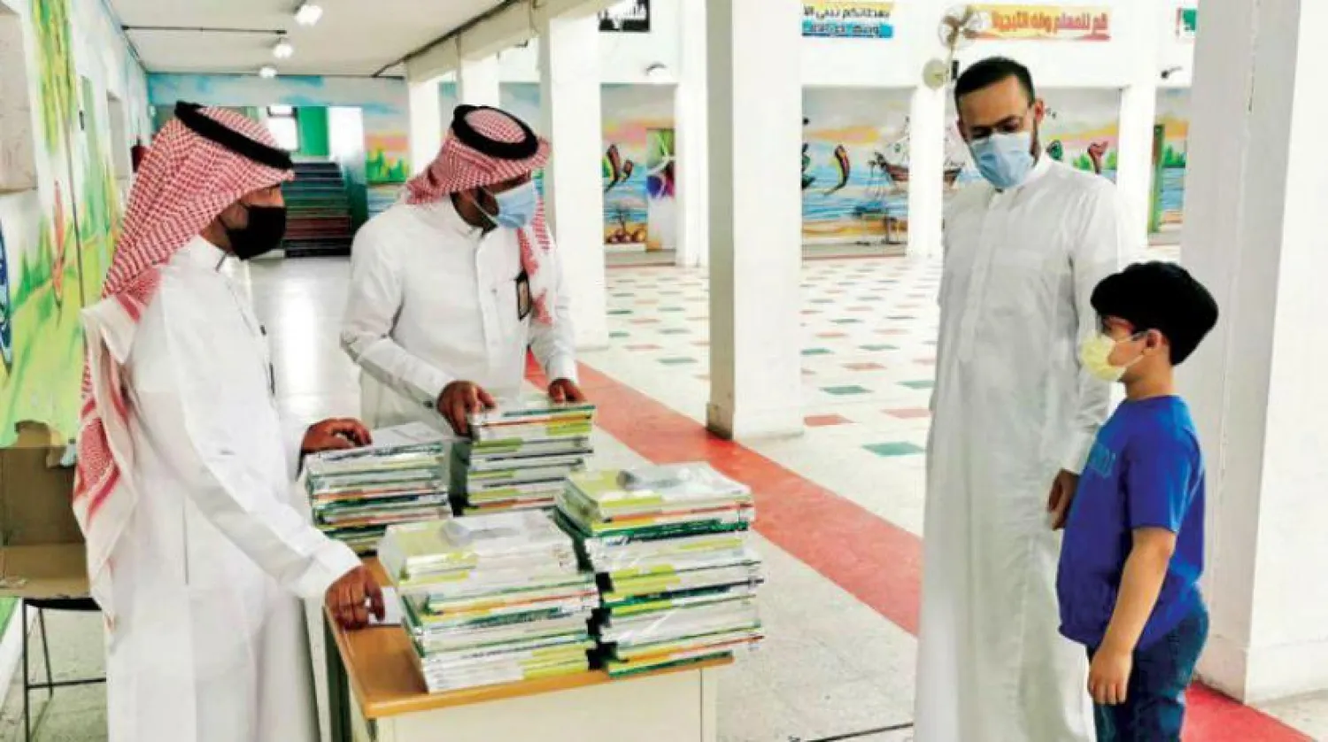 School books are handed out to students before the beginning of the academic year. (Ministry of Education via Twitter)