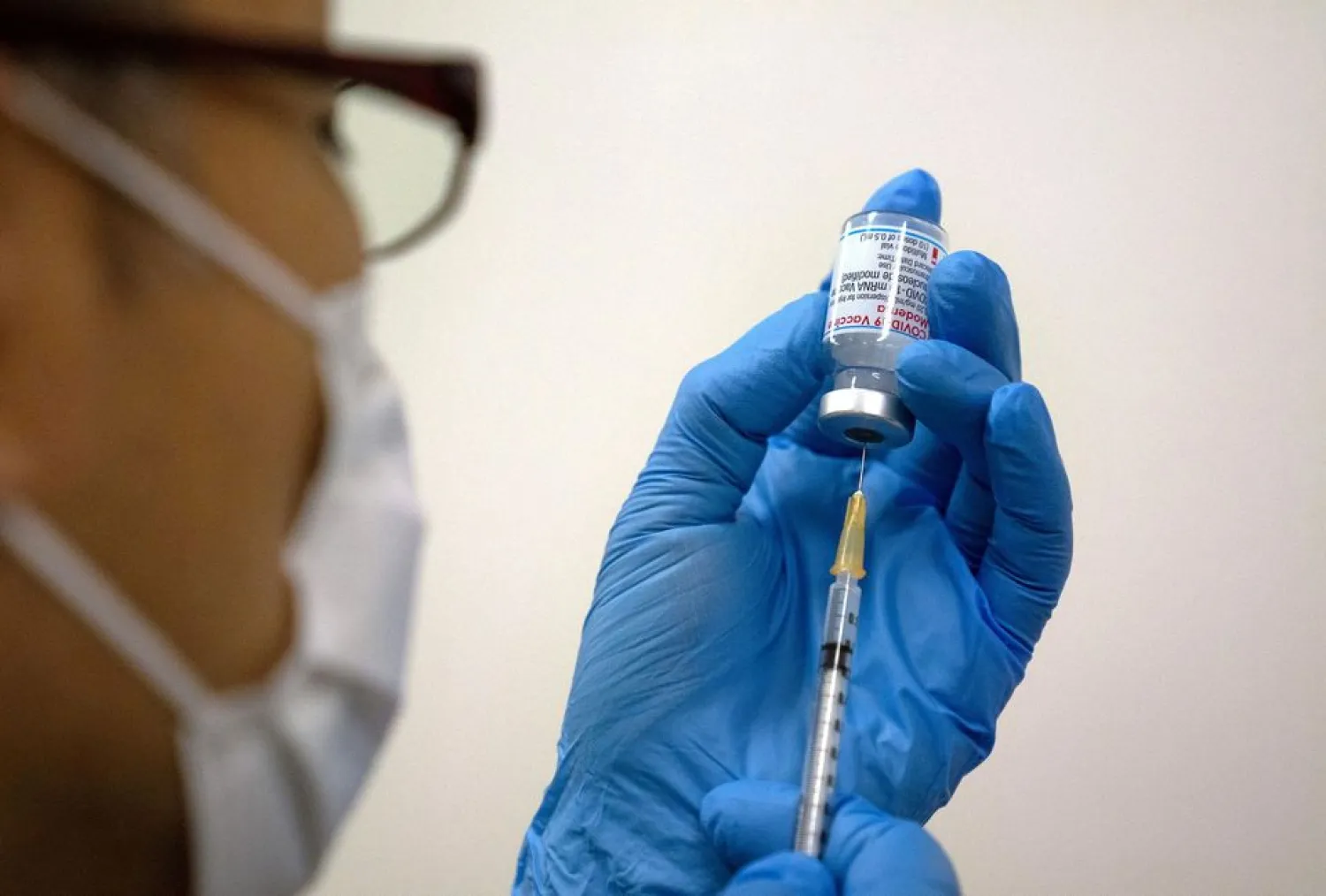 Medical staff prepares Moderna coronavirus disease (COVID-19) vaccine to be administered at the newly-opened mass vaccination center in Tokyo, Japan, May 24, 2021. Carl Court/Pool via REUTERS/File Photo/File Photo
