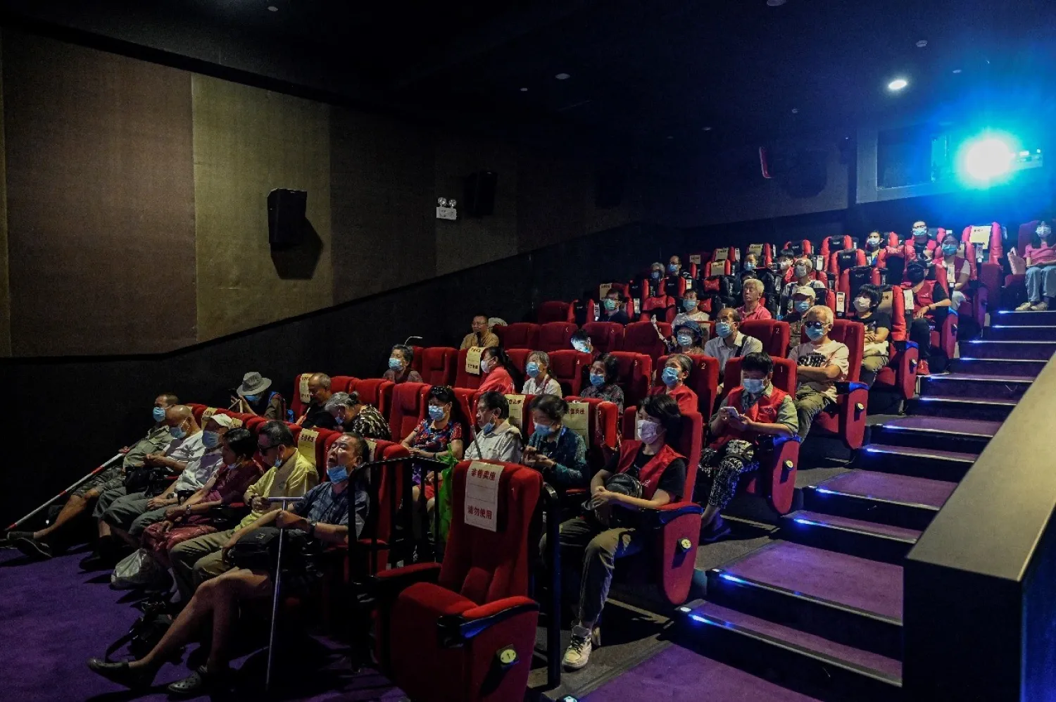 Dozens of blind moviegoers come to Saturday screenings organized by Xin Mu Theater. Jade GAO AFP

