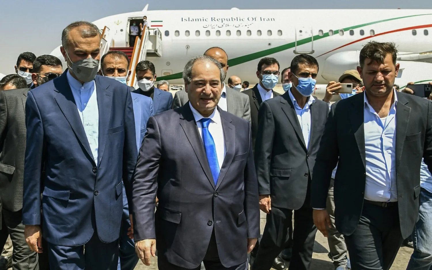 In this photo released by the Syrian official news agency SANA, Syria's Foreign Minister Faisal Mekdad, center left, receives Iran's new Foreign Minister Hossein Amir-Abdollahian, left, in Damascus, Syria, August 29, 2021. (SANA via AP)