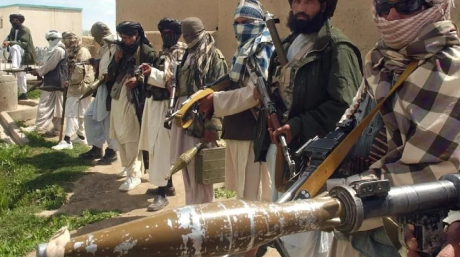 Taliban militants in a line holding guns and explosives. Photo: AFP
