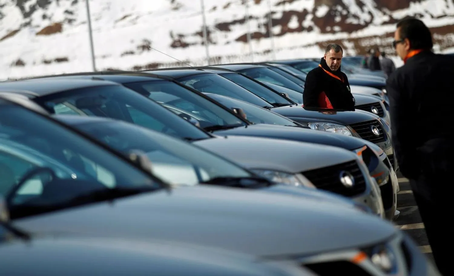 People look at a line of Great Wall cars parked in front of the newly opened car factory of Great Wall Motor Co near the town of Lovech, some 150 km northeast of Sofia February 21, 2012. (Reuters)