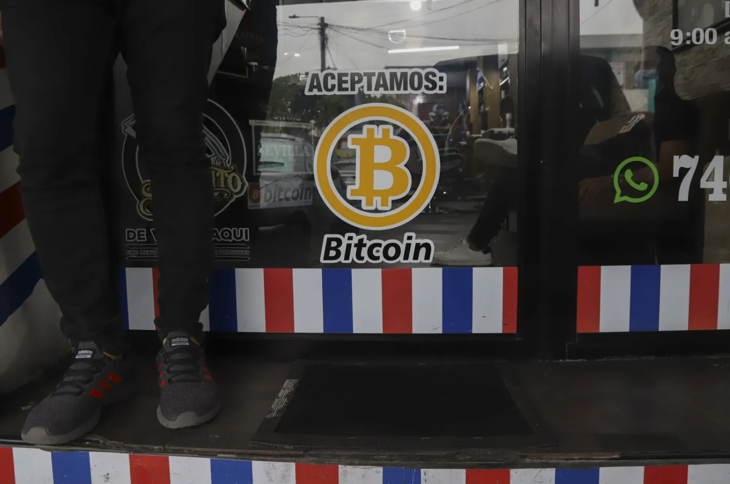 "We accept Bitcoin" is announced at a barber shop in Santa Tecla, El Salvador, Sept. 4, 2021. (AP Photo)
