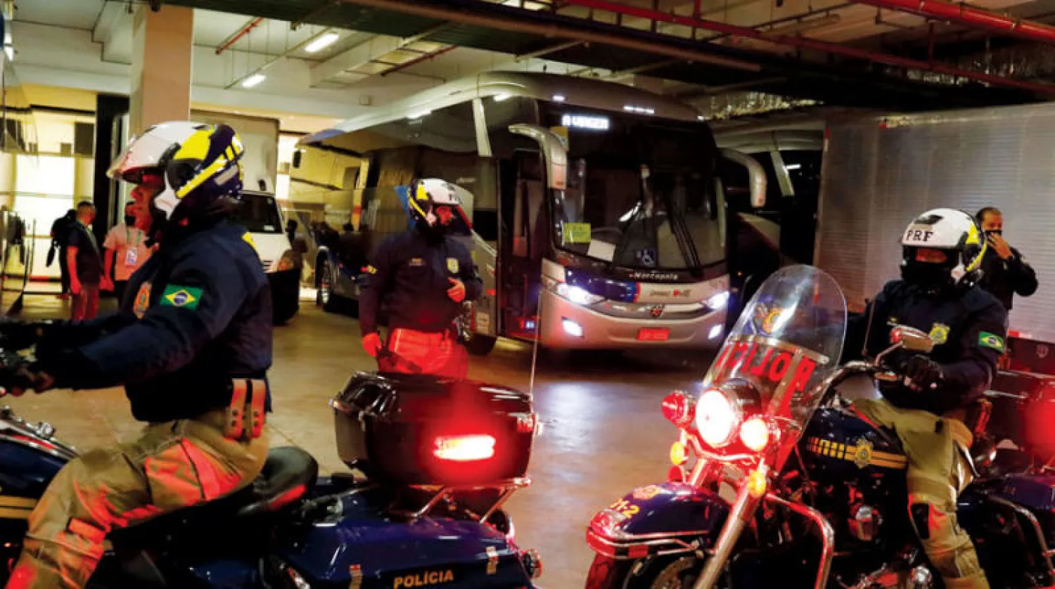 حافلة المنتخب الأرجنتيني في حراسة الشرطة البرازيلية خلال مغادرتها بوينس آيرس (رويترز)