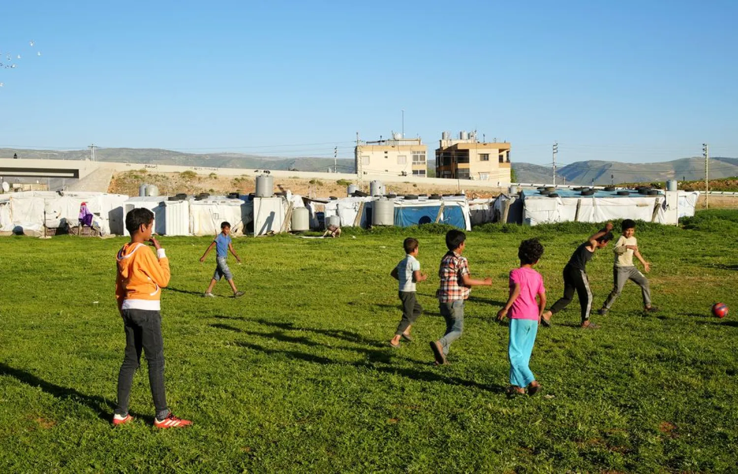 Syrian refugee youths play together at an informal tented settlement in Bar Elias, in the Bekaa Valley, Lebanon April 22, 2021. REUTERS/Issam Abdallah
