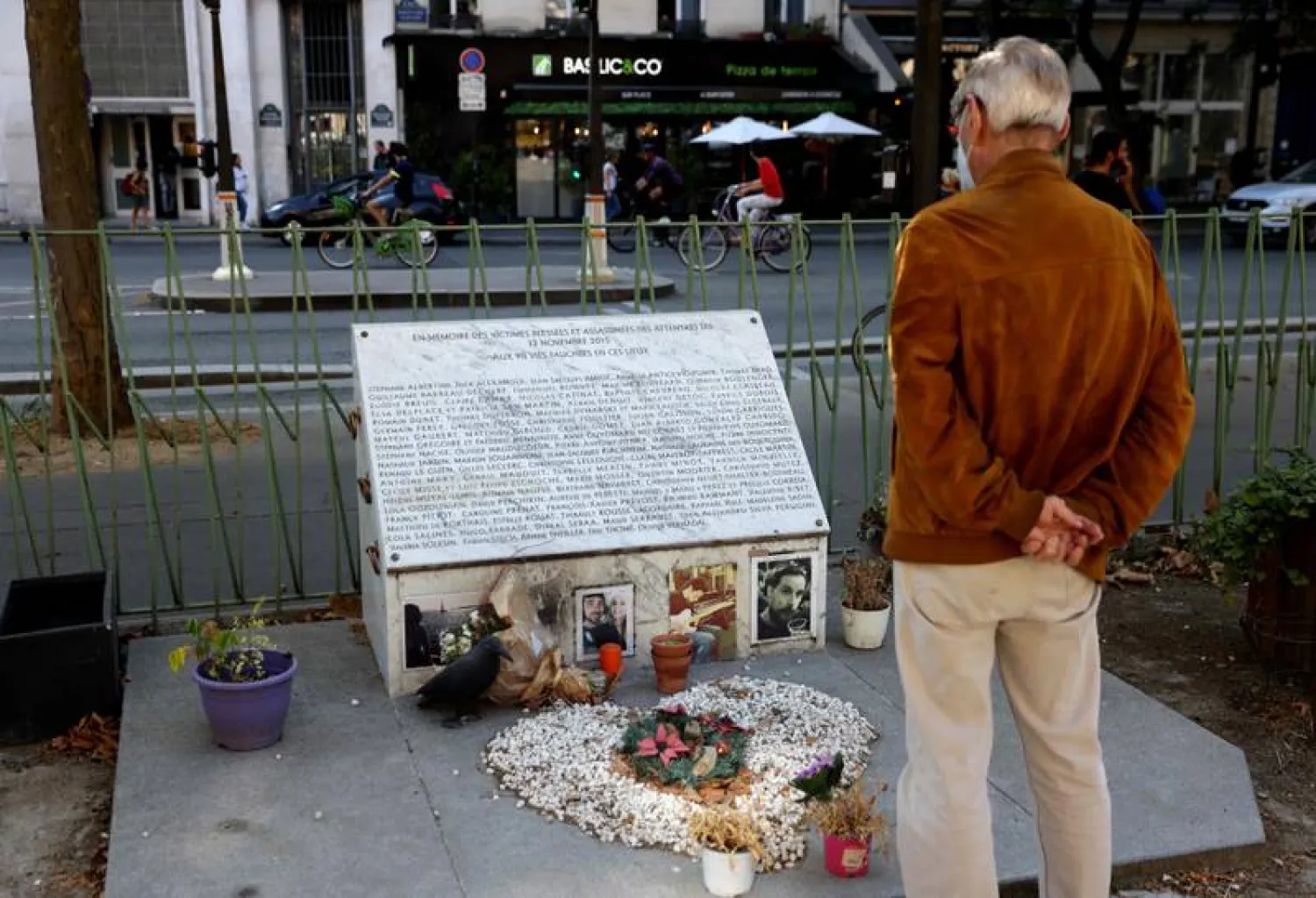 A man looks at the memorial plaque near the Bataclan theater and cafe in Paris, where extremists killed 90 people on November 13, 2015. AFP