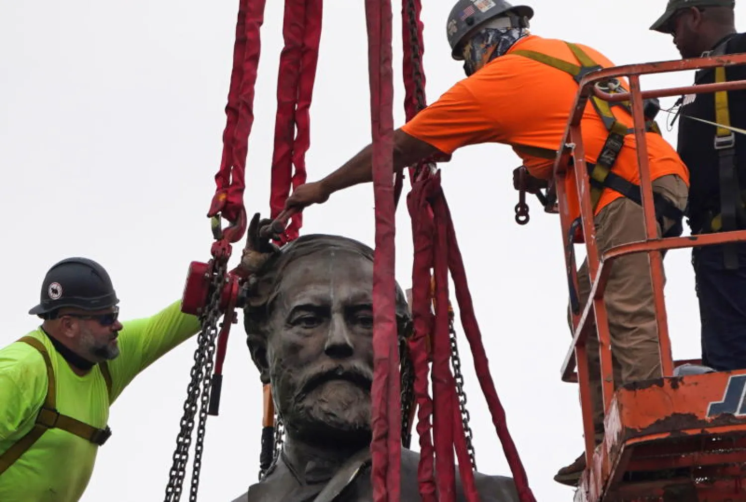 العمال وهم يزيلون تمثال الجنرال الكونفدرالي روبرت لي في ولاية فيرجنيا (رويترز)
