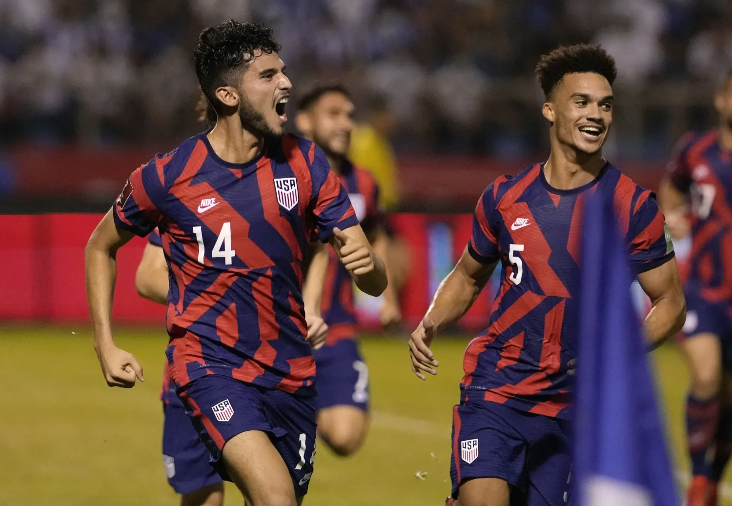 United States' Antonee Robinson, right, and his teammate Brenden Aaronson celebrate at the end of the game against Honduras during a qualifying soccer match for the FIFA World Cup Qatar 2022, in San Pedro Sula, Honduras, Wednesday, Sept. 8, 2021. United States won 4-1. (AP Photo/Moises Castillo)