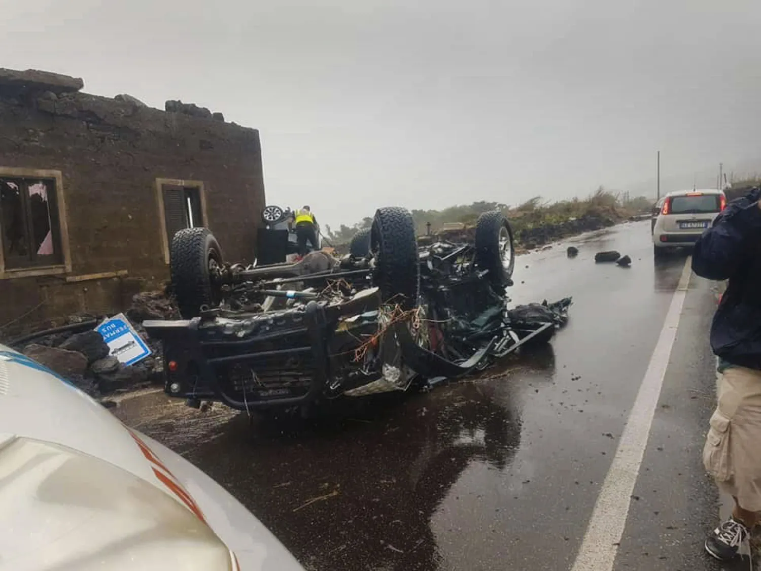 The hulk of a car that was swiped by a tornado lays on a road in the Italian southern island of Pantelleria, Sicily, Friday, Sept. 10, 2021. (Protezione Civile via AP)