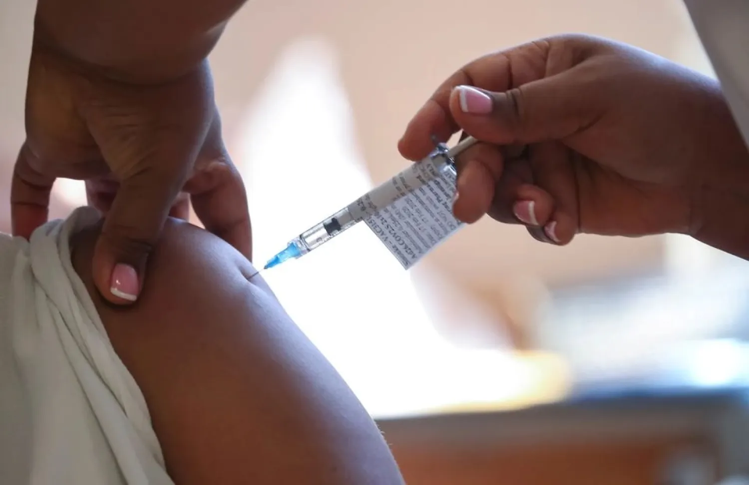 A healthcare worker receives the Johnson and Johnson coronavirus disease (COVID-19) vaccination at Khayelitsha Hospital near Cape Town, South Africa, February 17, 2021. (Reuters)
