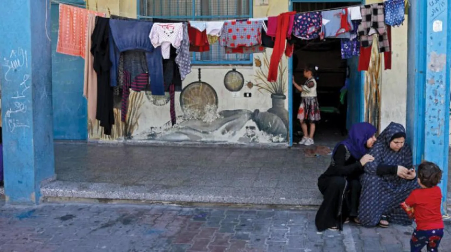 Families take shelter at an UNRWA school after Israeli raids on Gaza in May. (AFP)