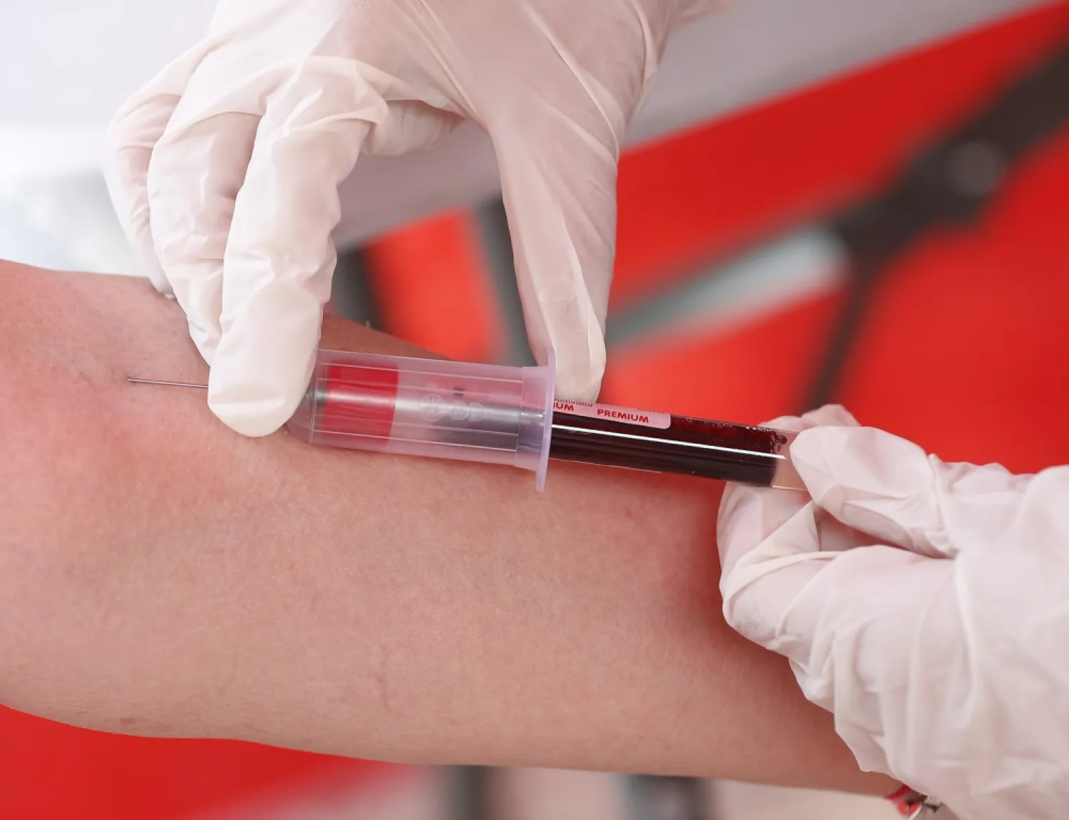 A staff member takes blood for an antibody test in Budapest, Thursday, July 8, 2021. (AP)