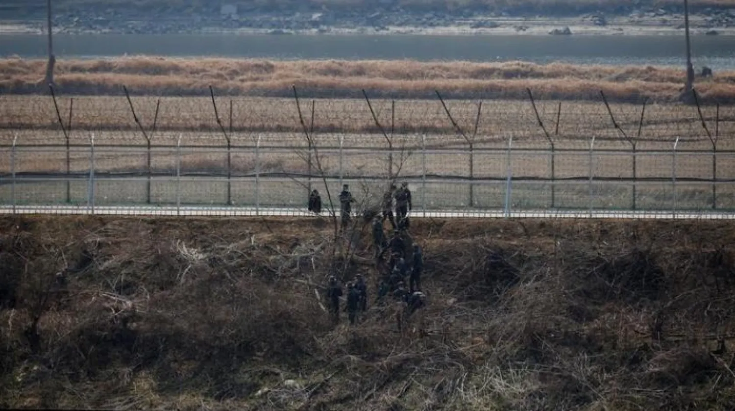 South Korean soldiers work in front of a military fence near the demilitarized zone separating the two Koreas in Paju, South Korea, March 24, 2021. (Reuters)

