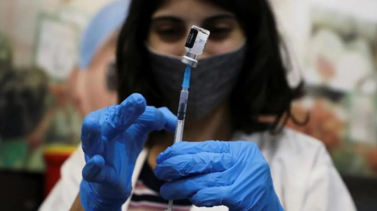 A medical worker prepares to administer a patient’s third dose of the coronavirus disease (COVID-19) vaccine at Clalit Healthcare Maintenance Organization in Jerusalem, August 13, 2021. (Reuters)
