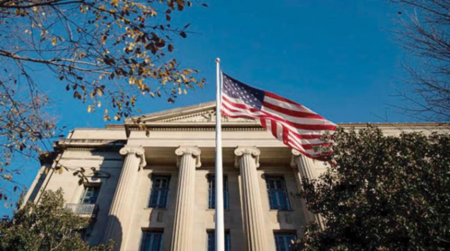 An American flag waves outside the US Department of Justice Building in Washington, US, December 15, 2020. REUTERS/Al Drago