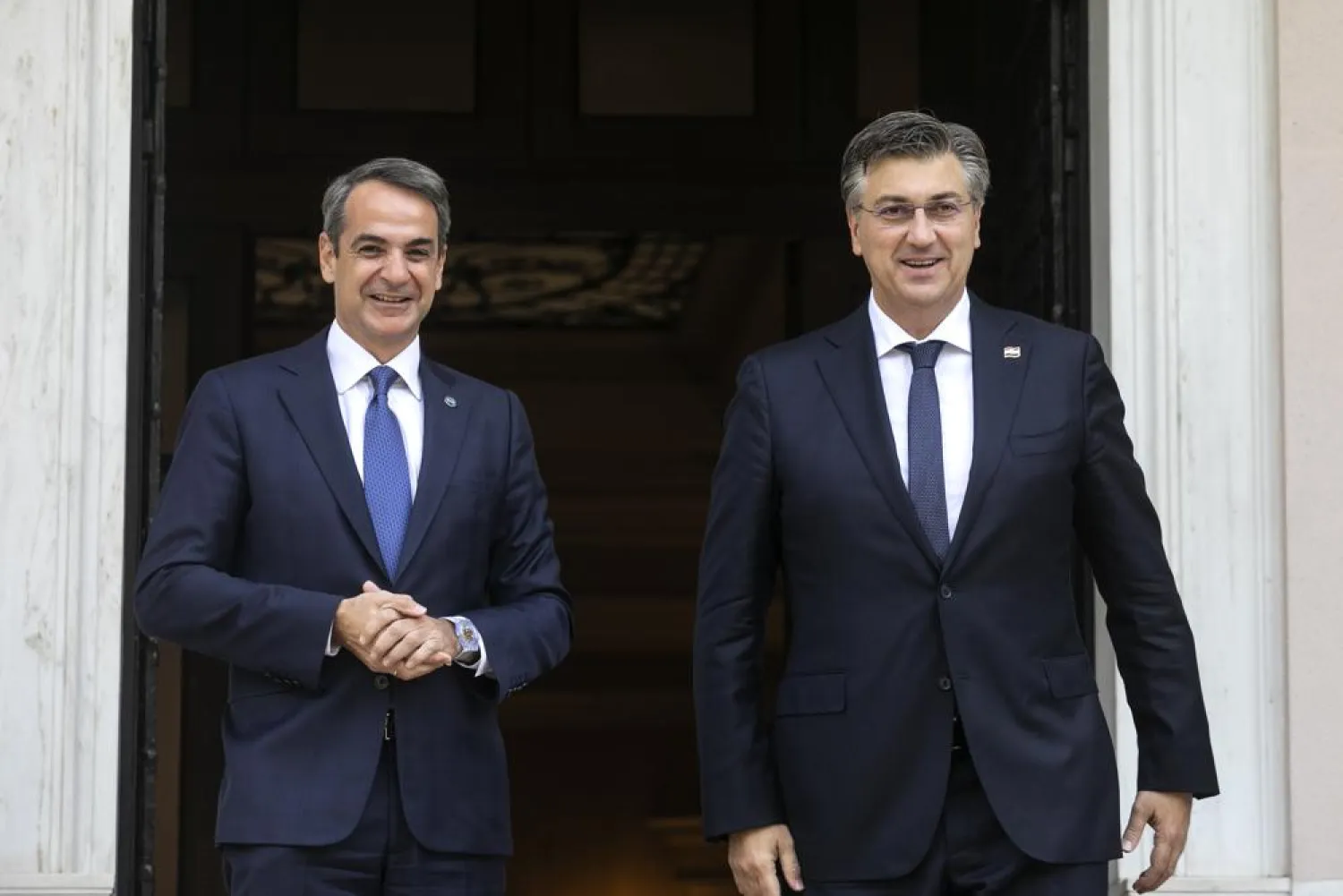 Greece's Prime Minister Kyriakos Mitsotakis, left, poses with his Croatian counterpart Andrej Plenkovic in Athens, Friday, Sept. 17, 2021. Plenkovic is in Athens to attend a Mediterranean summit. (AP Photo/Yorgos Karahalis)
