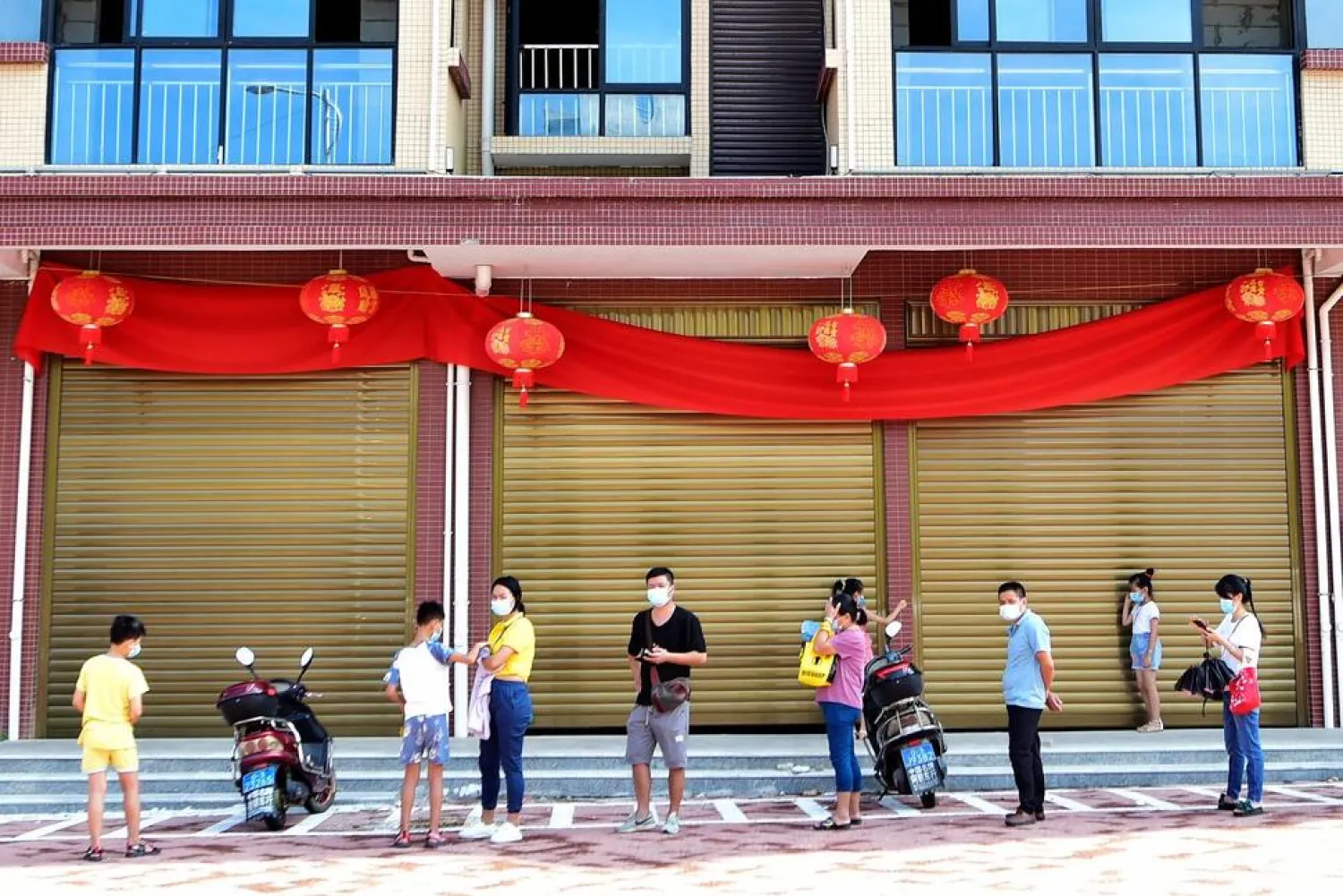 In this photo released by Xinhua News Agency, residents wait in line for nucleic acid testing in Xianyou county, Putian city, southeastern China's Fujian Province Thursday, Sept. 16, 2021. (Wei Peiquan/Xinhua via AP) 
