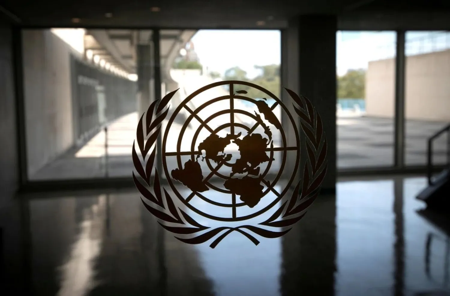 The United Nations logo is seen on a window in an empty hallway at United Nations headquarters during the 75th annual UN General Assembly high-level debate in New York, US, September 21, 2020. (Reuters)