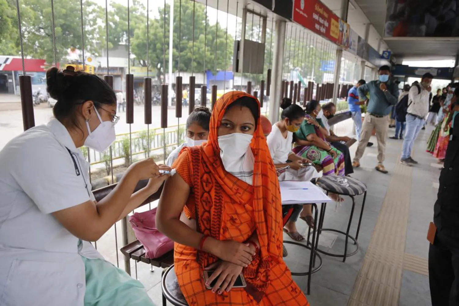 A health worker administers the vaccine for COVID-19 during a special vaccination drive by the municipal corporation at a bus stand in Ahmedabad, India, Friday, Sept. 17, 2021. (AP Photo/Ajit Solanki)
