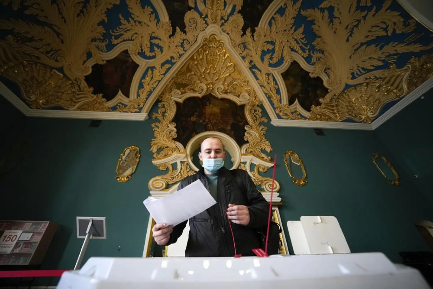 A man casts a ballot at a polling station at the Kazansky railway station during the Parliamentary elections in Moscow, Russia, Saturday, Sept. 18, 2021. (AP)