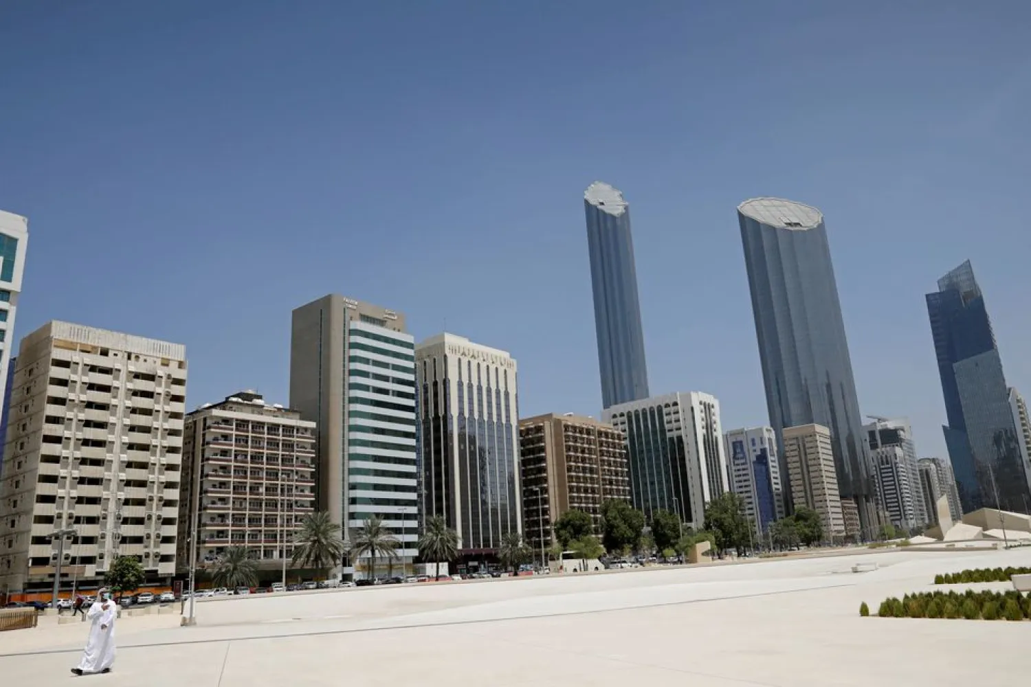 An Emirati man wears a protective mask as he walks past buildings in Abu Dhabi, United Arab Emirates September 1, 2020. (Reuters)