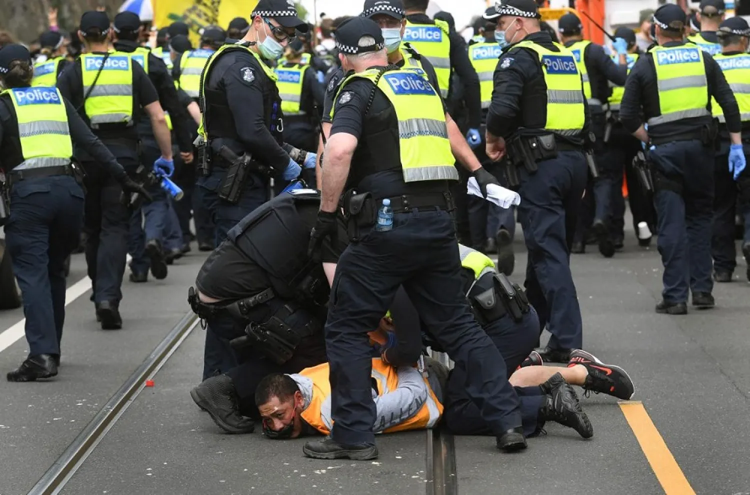 Police arrest a protester during an anti-lockdown rally in Melbourne on September 18, 2021. (AFP)