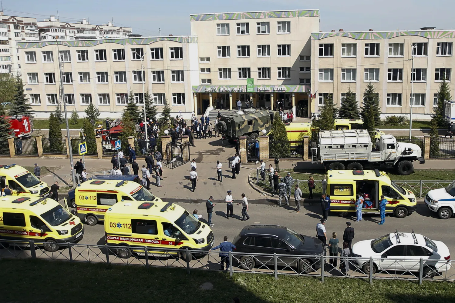 Ambulances, police cars and a truck are parked at a school after a shooting in Kazan, Russia, May 11, 2021. (AP Photo/Roman Kruchinin)
