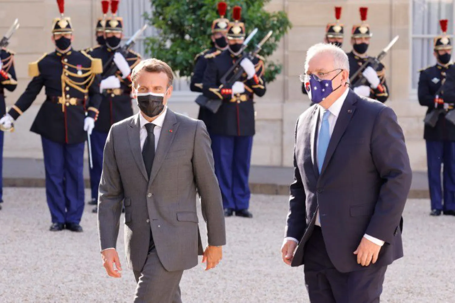 French President Emmanuel Macron and Australian Prime Minister Scott Morrison walk in front of the Elysee Palace in Paris, France, June 15, 2021. (Reuters)