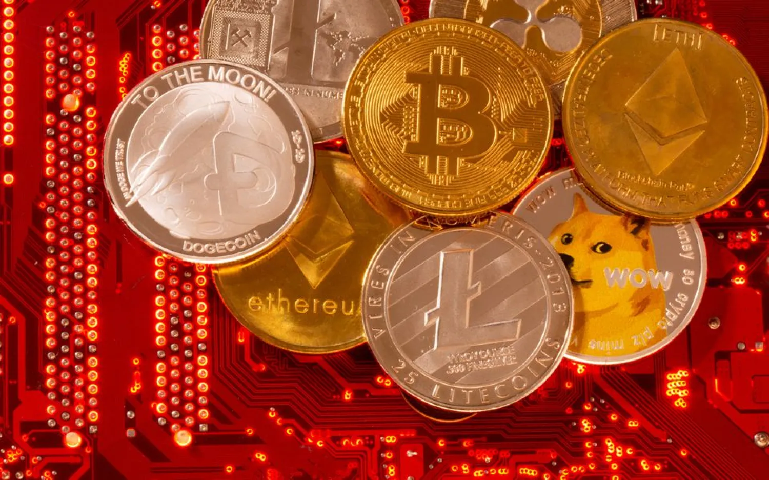 Representations of cryptocurrencies Bitcoin, Ethereum, DogeCoin, Ripple, Litecoin are placed on PC motherboard in this illustration taken, June 29, 2021. (Reuters)